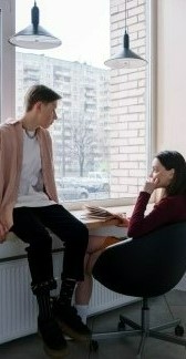 Фото, где в комнате сидят парень с девушкой и разговаривают на английском