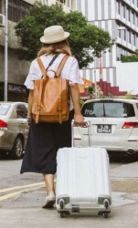 Фото, где девушка с чемоданом в незнакомом городе